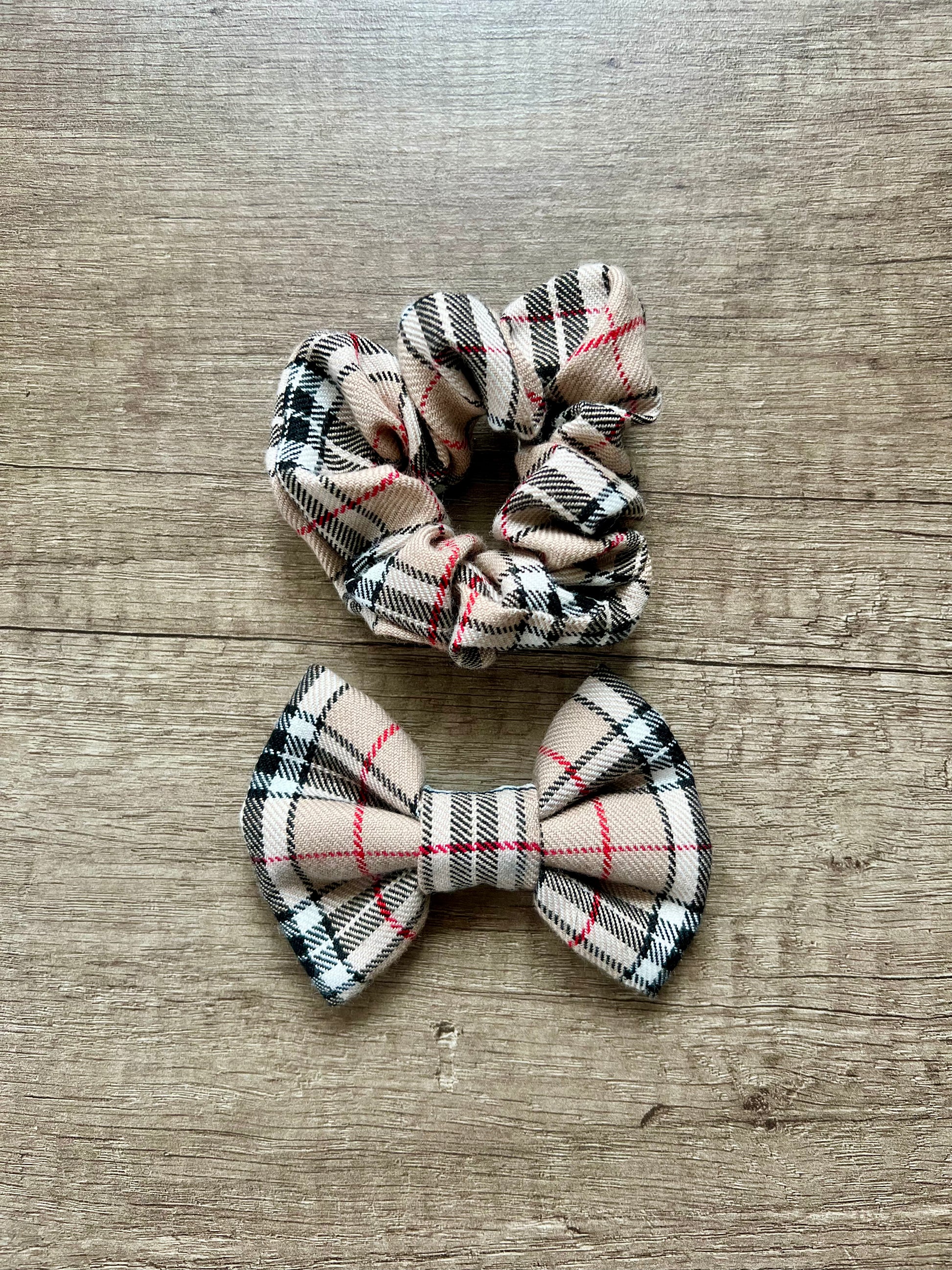 Plaid scrunchie and bow on a wooden surface