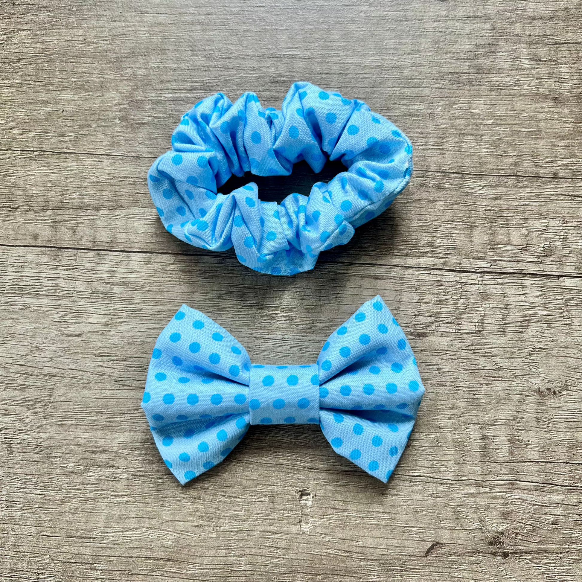 Blue polka dot scrunchie and bow on a wooden surface