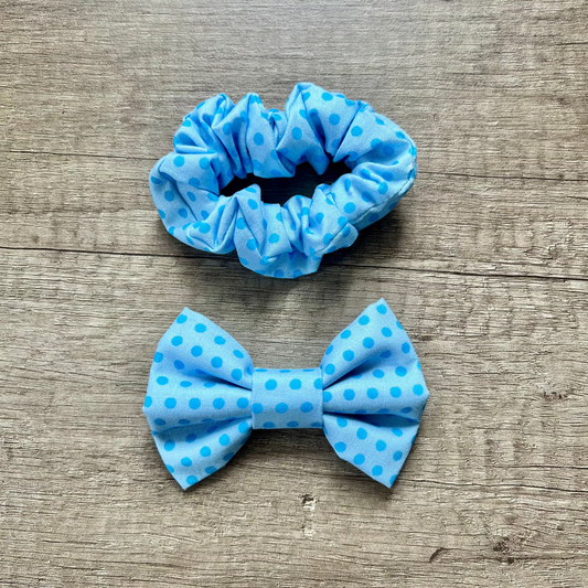 Blue polka dot scrunchie and bow on a wooden surface